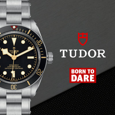 TUDOR watch on gray background with "born to dare"