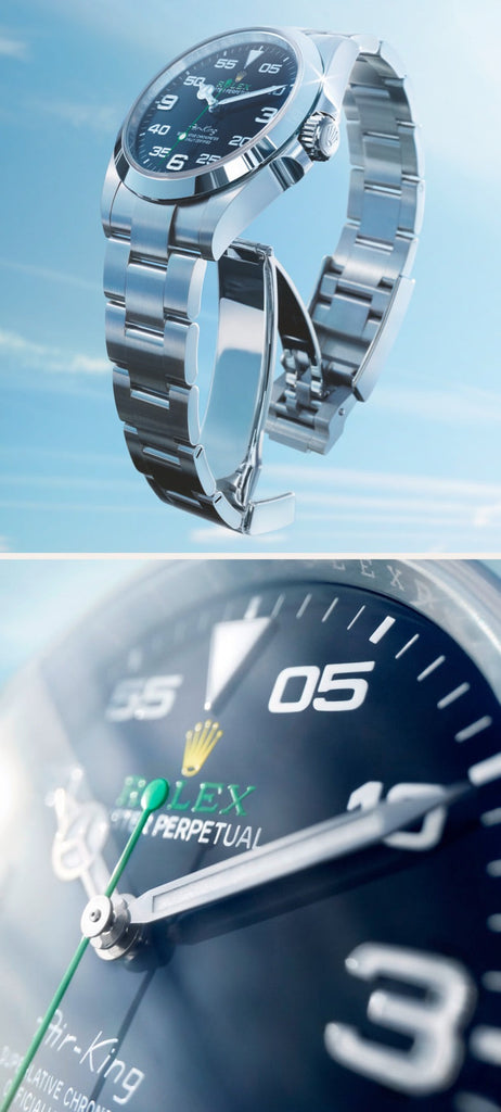 A split image of a luxury watch. The left side shows the silver bracelet watch in an upright position against a light blue sky background. The right side provides a close-up shot of the dark face, highlighting the white numbers and the brand's logo.